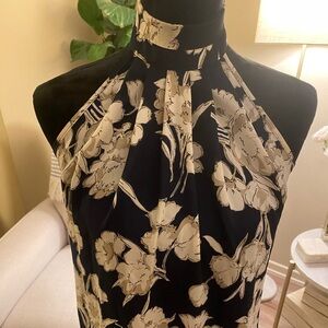 Blue and beige sleeveless collared blouse with floral print. Size XS.